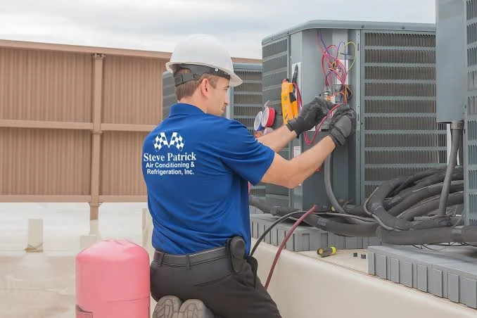 Illustrative technician using a diagnostic meter on an outdoor HVAC unit