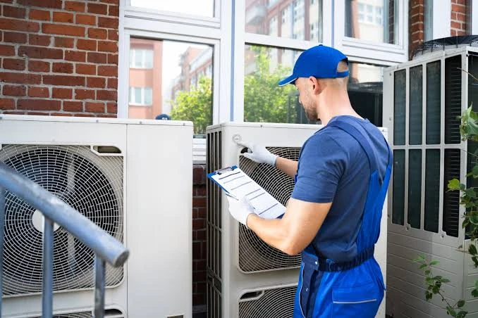 Illustrative technician using a clipboard to document an outdoor system inspection