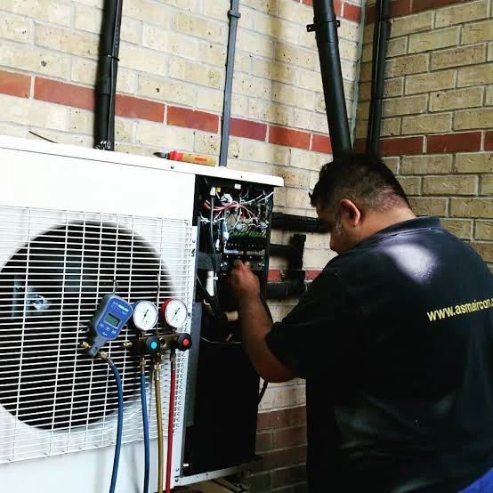 Illustrative technician troubleshooting an outdoor condenser with pressure gauges